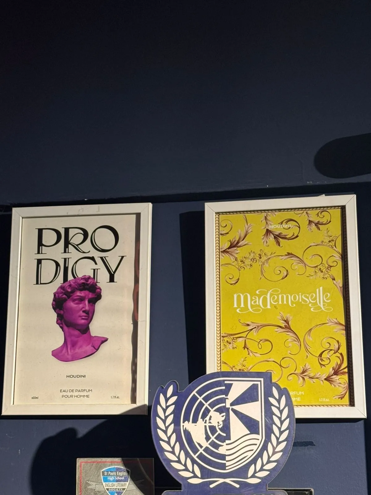 Houdini Perfumes Prodigy and Mademoiselle posters framed on a wall