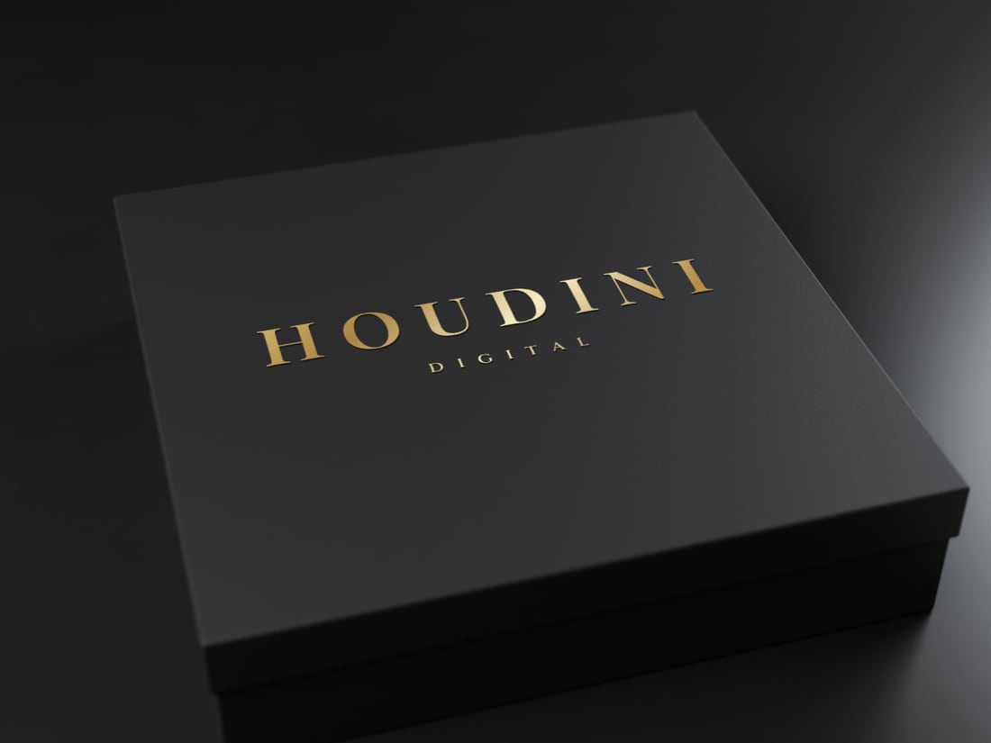 A black gift box with a logo pressed in gold foil