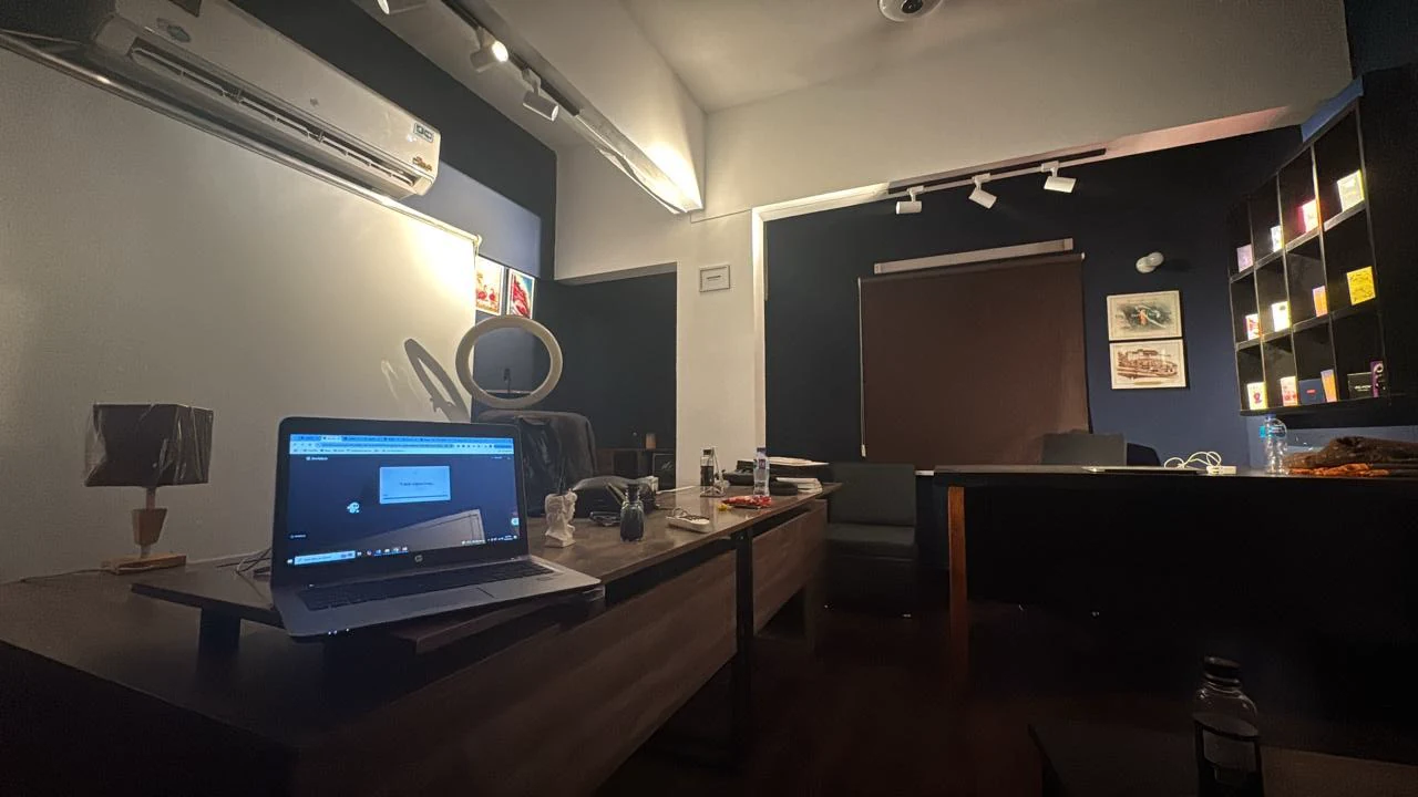Wide view of the Houdini Digital workspace with desks, display shelving and track lighting